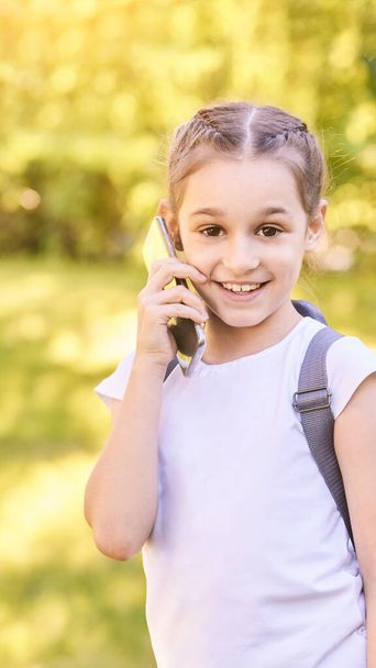 Cute little girl talking. Hold phone near face - Photo, Image
