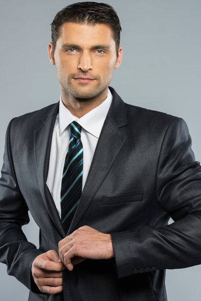Well-dressed handsome man in black suit and tie - Fotó, kép