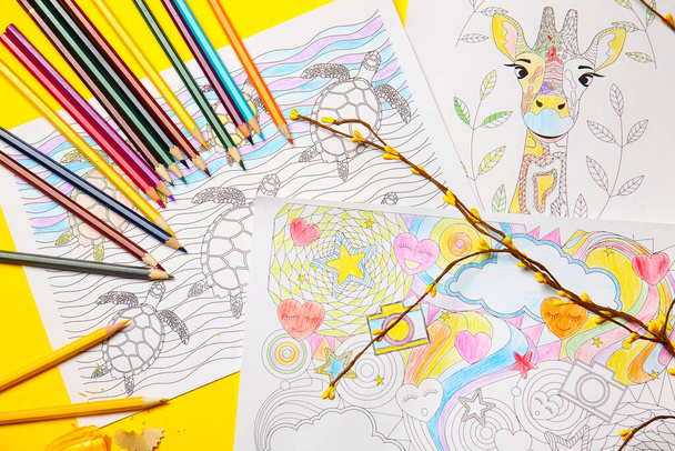 Coloring pictures and pencils on table - Photo, Image