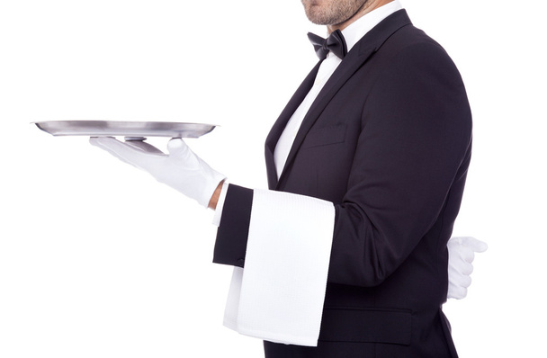Cropped image of a young waiter holding an empty dish on white b - Photo, Image
