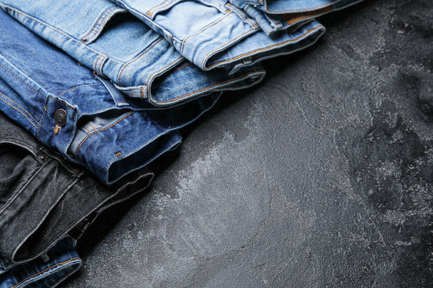 Stylish jeans pants on dark background - Photo, Image
