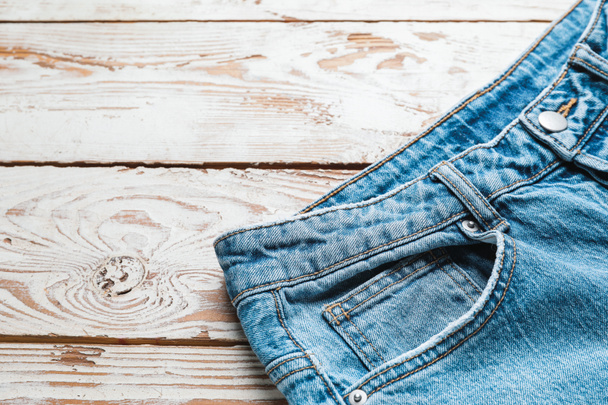 Stylish jeans pants on wooden background - Photo, Image