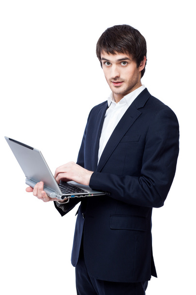 Young businessman use laptop on white background. - Foto, afbeelding