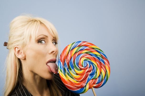 Woman licking a lollipop - Foto, Imagen