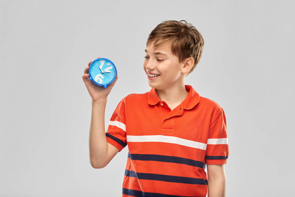 portrait of happy smiling boy with alarm clock - Foto, immagini