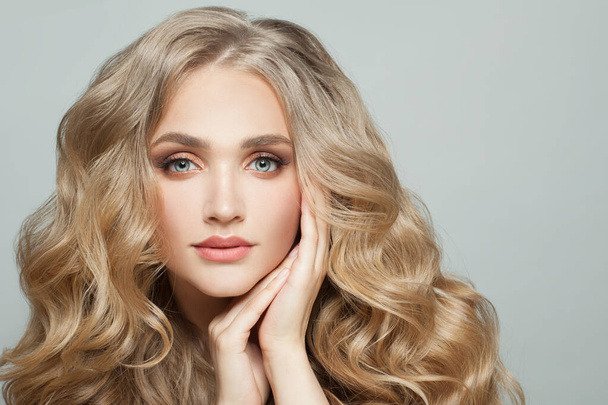 piękny kobieta model twarz z długo zdrowe blondynka kręcone włosy na biały - Zdjęcie, obraz