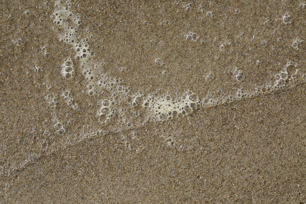 Closeup of water bubbles in the sand - Photo, Image