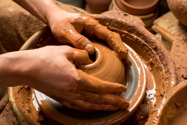 hands of a potter, creating an earthen jar - Photo, Image