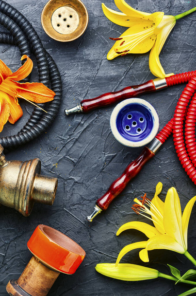 Asian smoking hookah with fragrant flower tobacco.Lily flavor shisha - Photo, Image