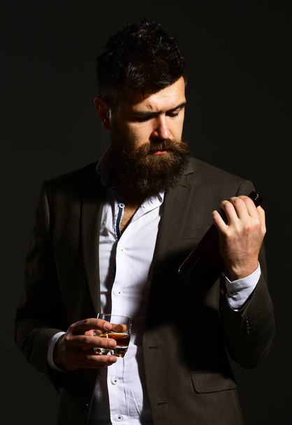 Sommelier with beard tasting alcohol. Businessman with confident face - Φωτογραφία, εικόνα
