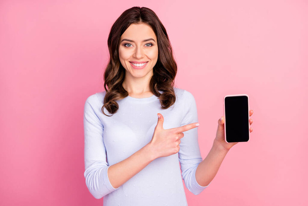 Photo of beautiful lady hold telephone hands directing finger touch screen advising amazing renew interface model sale manager wear casual white shirt isolated pastel pink color background - Foto, afbeelding