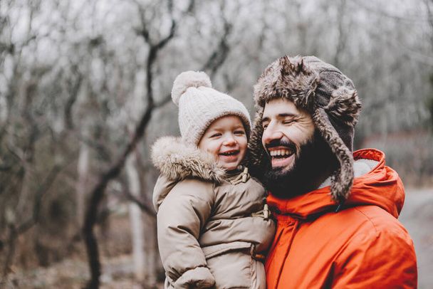 Handsome young dad and his little sweet daughter have fun outdoors in winter. Happy family spending time together. Family concept. - Fotografie, Obrázek