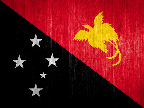 Papua neue Guinea-Flagge auf Holz-Hintergrund - Foto, Bild