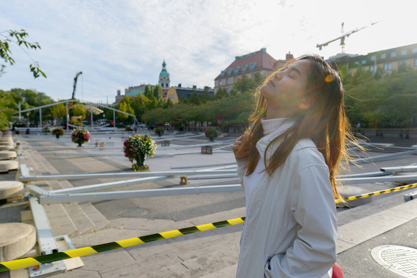 Portrait of young beautiful Asian tourist woman traveling around the city of Stockholm in Sweden - Foto, immagini