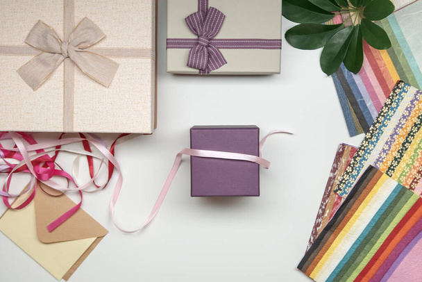 All things for gift wrapping on white background. Present box with bow. Ribbon and color paper. - Photo, Image