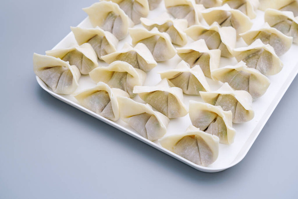 Traditional Chinese food wonton is placed on a white plate. The delicious wonton is on a plate. - Photo, Image