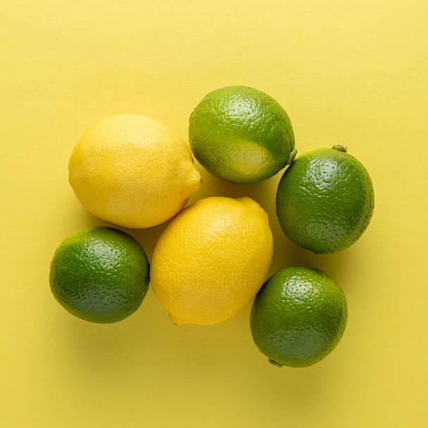 Lime and lemon on a bright background. Summer concept. - Φωτογραφία, εικόνα