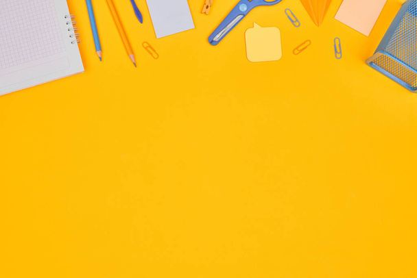 minimalism yellow-blue stationery on yellow background school, university, flat layer, copy space one - Foto, Imagem