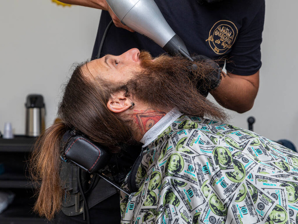 Man drying his beard at the barber . - Photo, Image