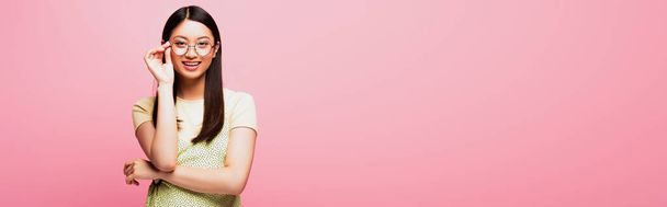 panoramic concept of happy asian girl touching glasses isolated on pink  - Fotografie, Obrázek