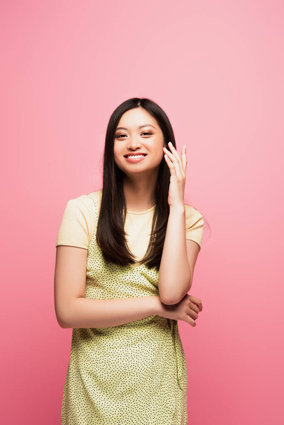 happy young asian woman looking at camera and smiling isolated on pink  - Фото, зображення