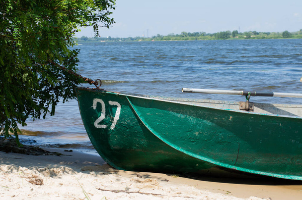 Boat on the sandy bank of the Dnieper river in Ukraine on a sunny summer day. - Photo, Image