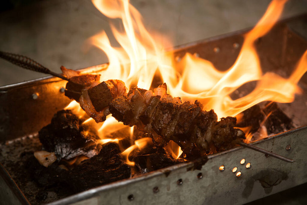 lighting coals for barbecue, open fire - Foto, afbeelding