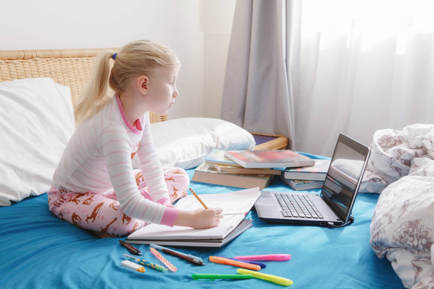 Kaukasisch meisje kind leren online op laptop Internet. Virtuele klas school op video oproep tijdens zelfisolatie quarantaine thuis. Afstandsonderwijs op afstand. Nieuw normaal onderwijs en thuisonderwijs. - Foto, afbeelding