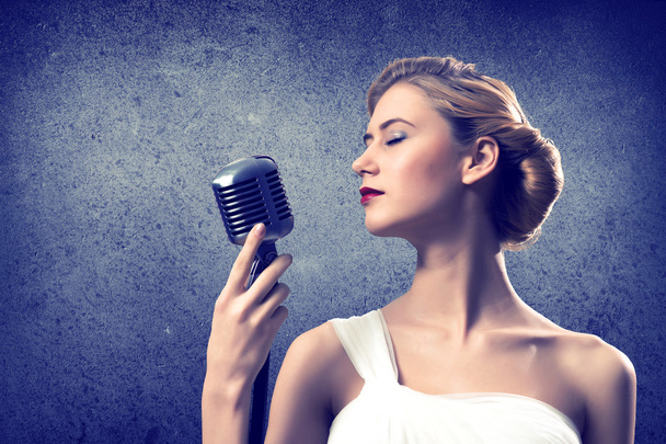 attractive female singer with microphone - Foto, Imagen