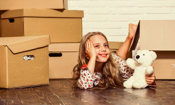 Girl small child and boxes. Move out concept. Kid moving out. Moving routine. Packaging things. Prepare for moving. Rent house. Real estate. Delivering your purchase. Dreaming about own room - Фото, зображення