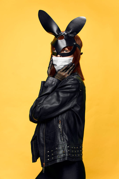  Female rabbit mask posing sexually in a medical mask from coronavirus - Valokuva, kuva