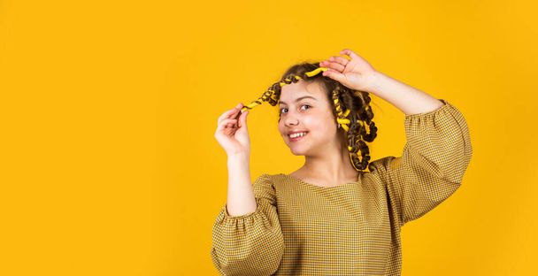childhood happiness. happy girl in hair curlers playing hairdresser salon. Easy tips making hairstyle for kids. hairdressing tools and hair accessories. kid pose with hair curlers - Fotografie, Obrázek
