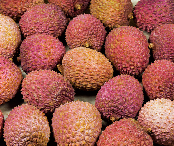 Litchi fruits on wooden surface - Fotó, kép