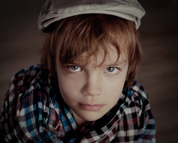 Portrait of boy on brown background, studio - Φωτογραφία, εικόνα