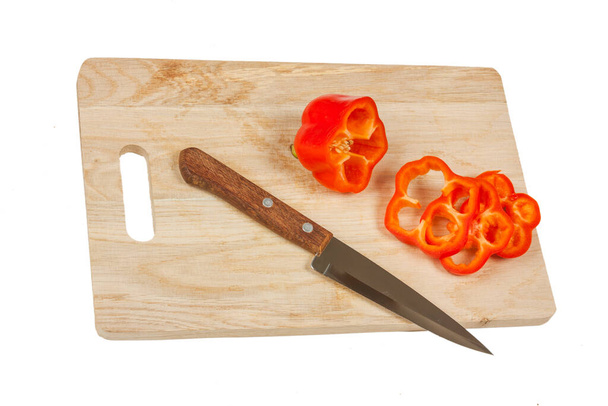 paprika with a knife on a cutting board isolated on a white background - Foto, imagen