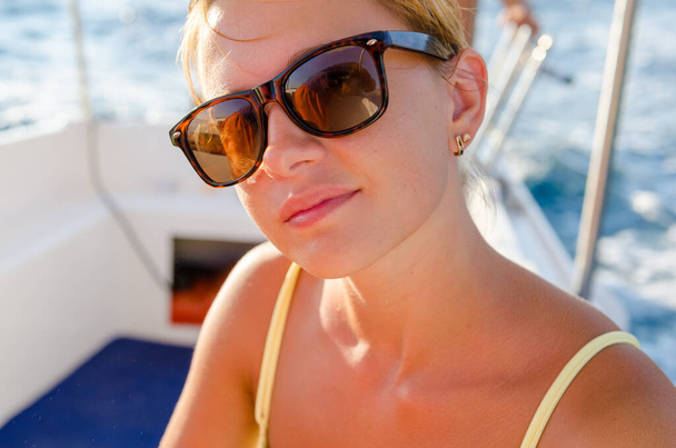 Red woman on a yacht cruise - 写真・画像
