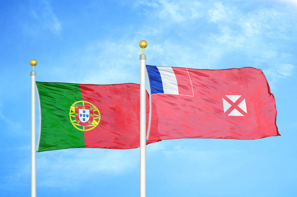 Portugal y Wallis y Futuna dos banderas sobre asta de bandera y fondo azul cielo nublado - Foto, imagen