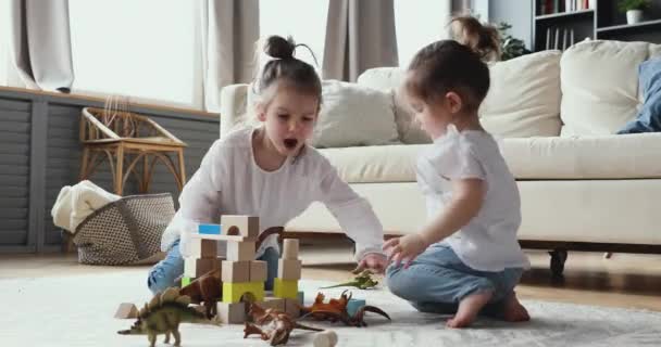 Two little preschool daughters children playing toys in living room. - 映像、動画