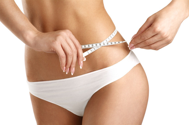 Closeup of a woman measuring her hips - Fotografie, Obrázek