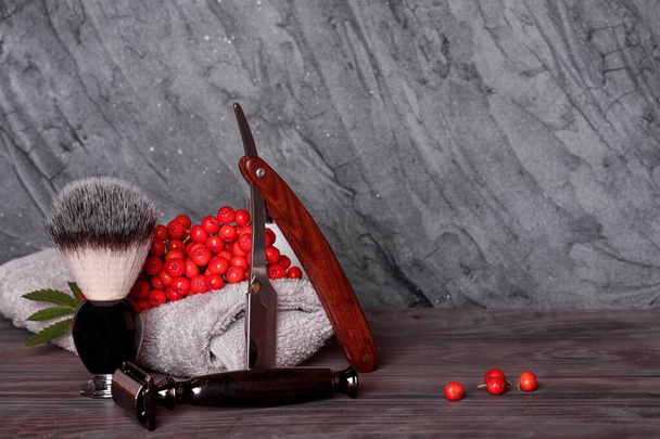 Razors, brush, towels and rowan  on a wood background. - Photo, Image