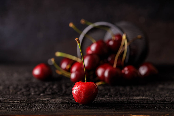 Група вишні на фоні темного дерева або столу. Соковиті свіжі вишневі ягоди. Крупним планом групу фруктів
 - Фото, зображення