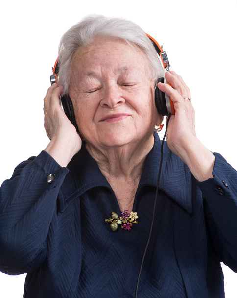 Old woman listening to music in headphones - Fotoğraf, Görsel