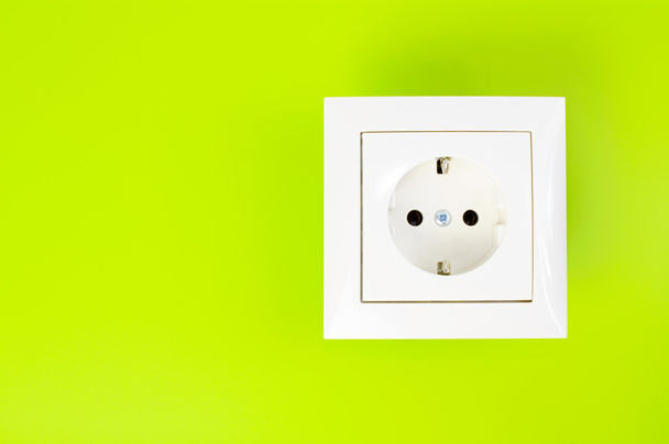 White power socket on green background - Photo, Image