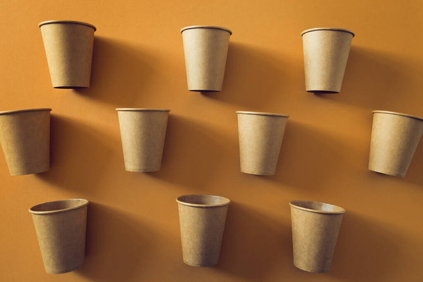 Eco friendly craft paper cups on pastel background. Recycling concept. Zero waste theme - 写真・画像