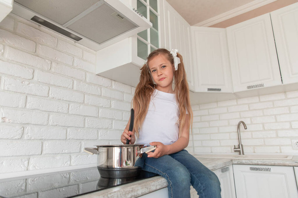 little girl with a pan and the ladle. Copy space - Photo, image