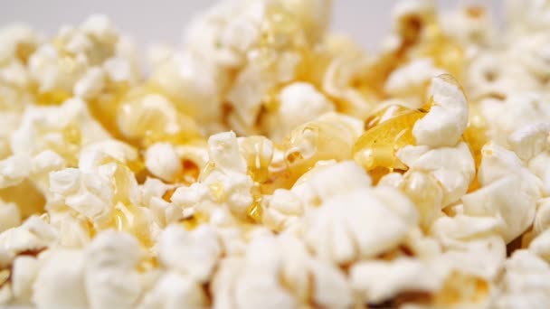 Honey spilling on heap of popcorn - Footage, Video