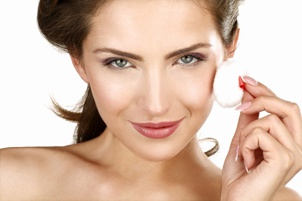 Closeup of a beautiful woman applying a beauty treatment - Fotografie, Obrázek