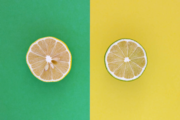 Lemon vs Lime. Yellow sliced lemon and green sliced lime close up. - Foto, afbeelding