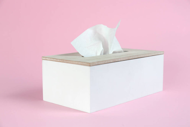 Holder with paper tissues on pink background - 写真・画像