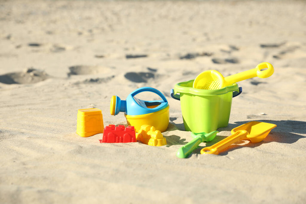 Different child plastic toys on sandy beach - Фото, зображення